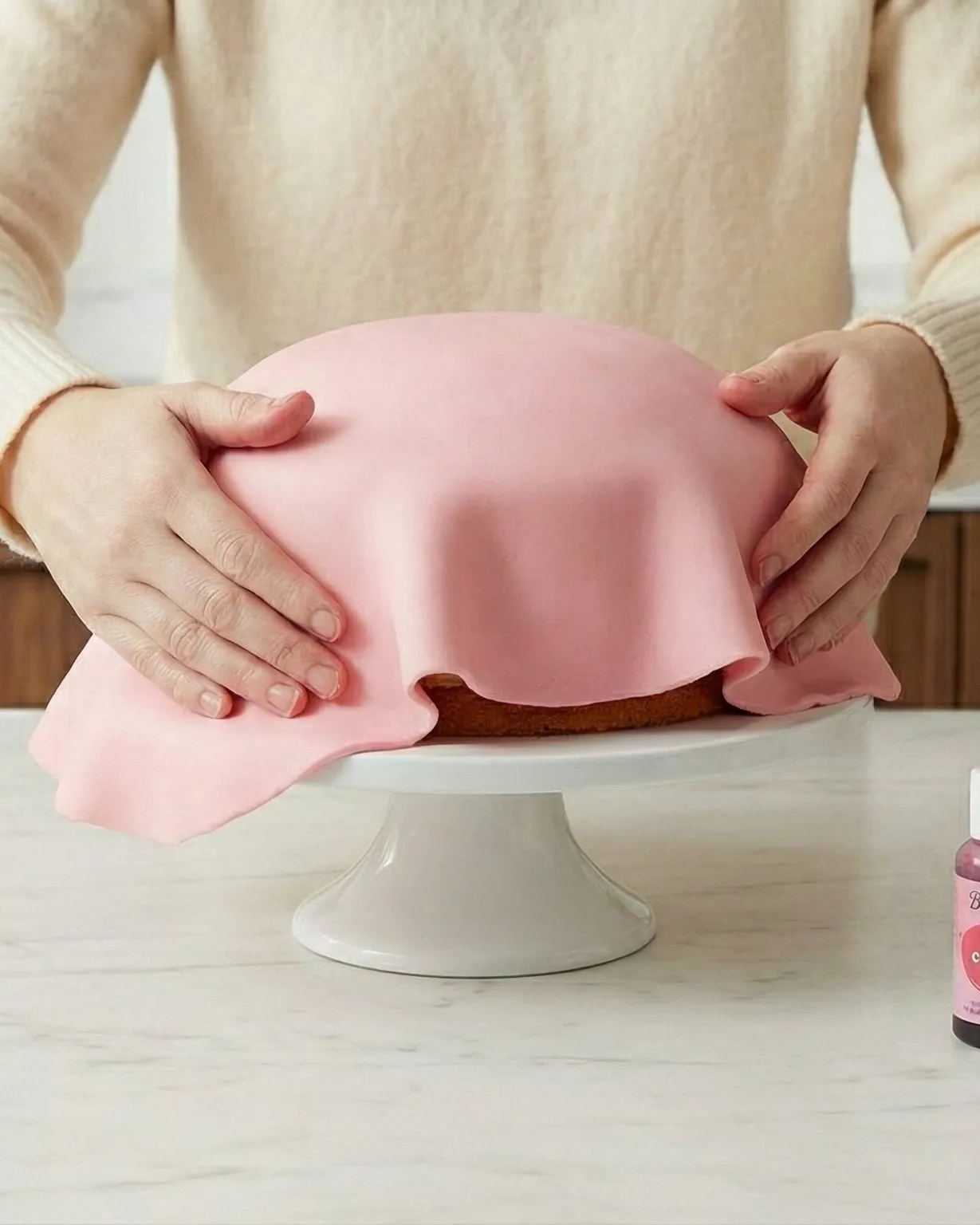 Master the technique of draping fondant over a cake for a smooth, professional finish. Learn how to handle fondant, smooth out air bubbles, and create a perfect covering. Essential skills for impressive cake decoration.